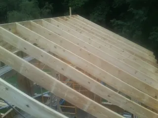 New roof rafters set over an addition before sheathing in Ozone Park